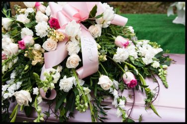 Bouquet of flowers on top of a casket