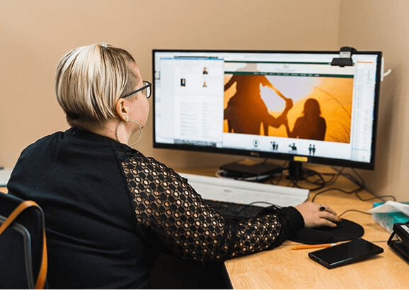 Answering Service for Directors' employee using her computer at her desk